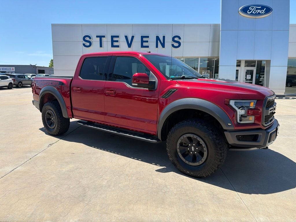 2018 Ford F-150 Raptor in Ruby Red Metallic Tinted Clearcoat — front three-quarter view